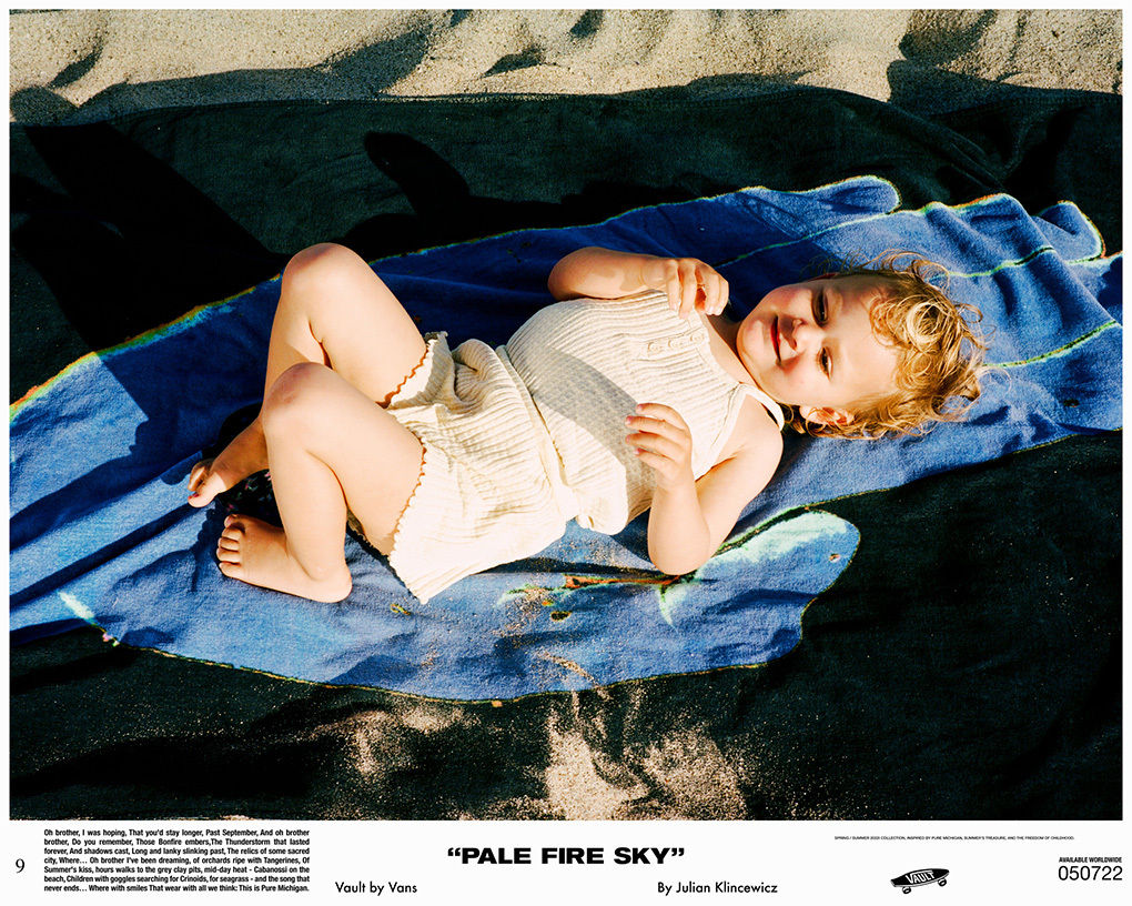 Toddler laying on beach towel at beach