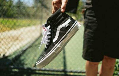 Black and white high top vans on feet hotsell