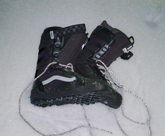 Cole Navin signature Hi Standard Pro boots laying on a patch of snow.