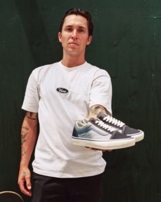 Elijah Berle holding a pair of Vans skateboarding shoes from his new collection.