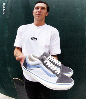 Elijah Berle holding a pair of Vans skateboarding shoes from his new collection.