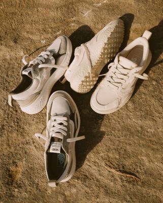 Two pairs of vans ultrarange neo vr3 shoes on the sand.