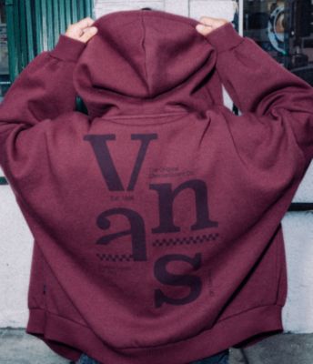 A person with their back facing the camera wearing  a Vans Broken Up Loose Full Zip Hoodie in Port Royale Red.