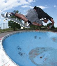 Vans skate team rider Zion Wright doing a skate trick at a skate park in blue Skate Old Skool 36+ shoes. 