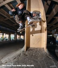 Vans skate team rider Nelly Morville performing a skateboarding trick in an urban setting.