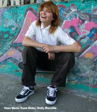 Vans skate team rider, Nelly Morville, sitting on a skateboard wearing the black and white Skate Old Skool 36+.