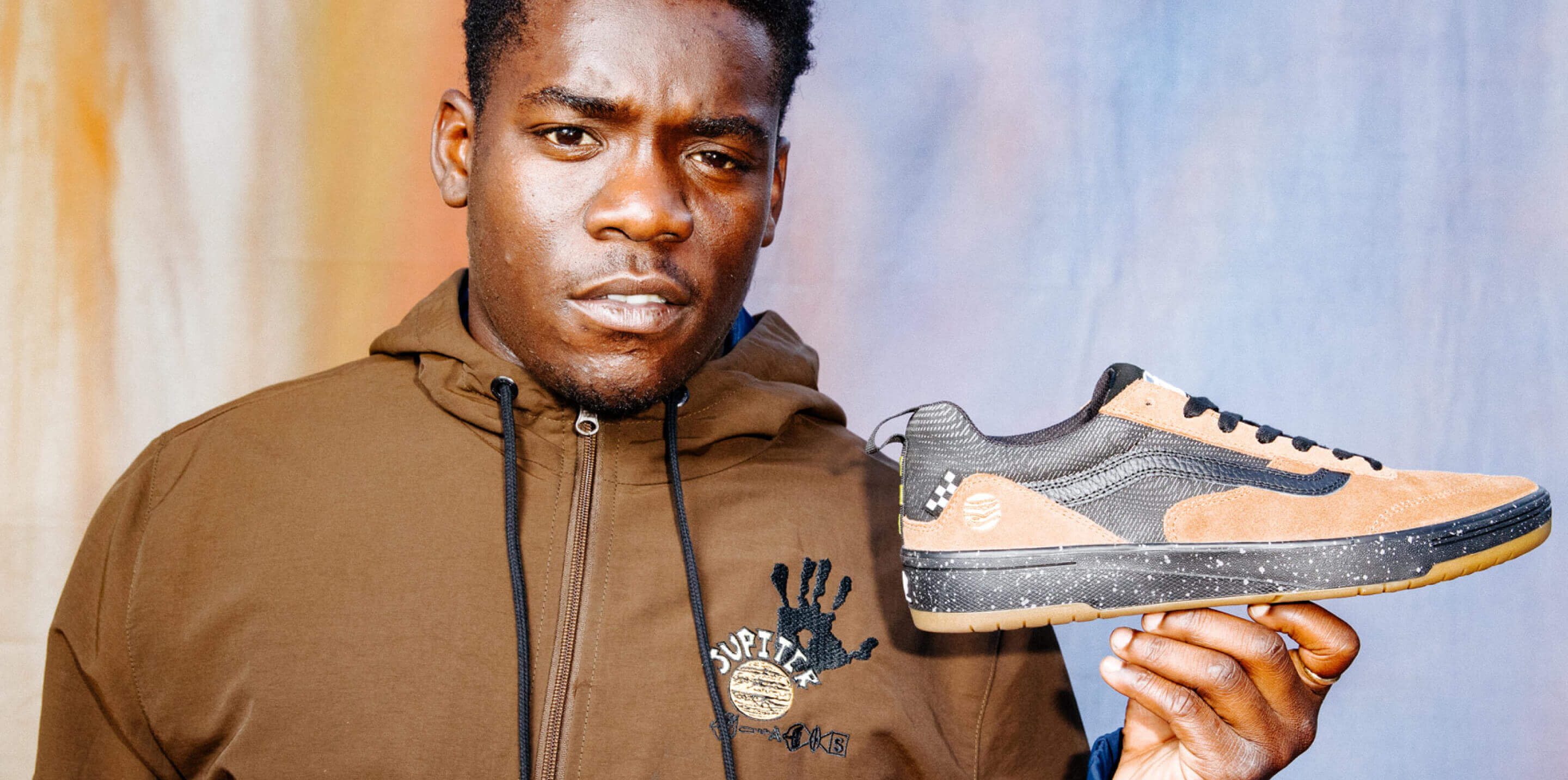 Zion Wright holding the zahba shoe with the Zion colorway.