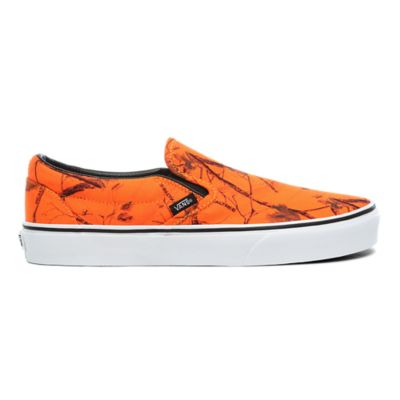 orange and white slip on vans